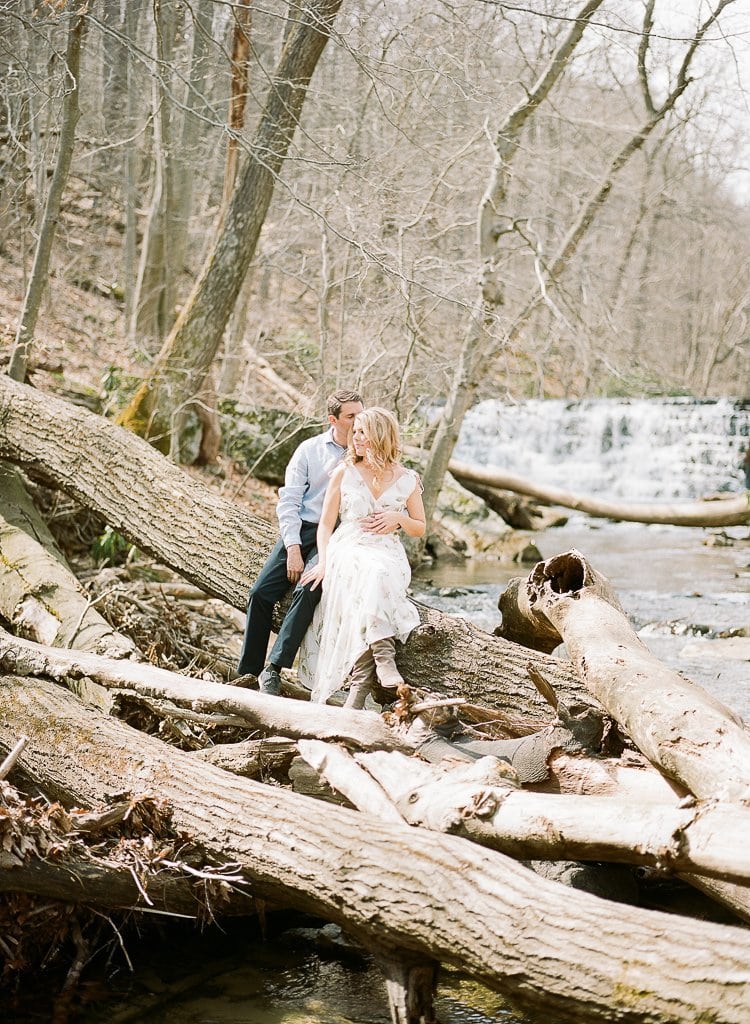 Engagement Session - Lauren Renee Photography bride and groom sitting on a log near the stream