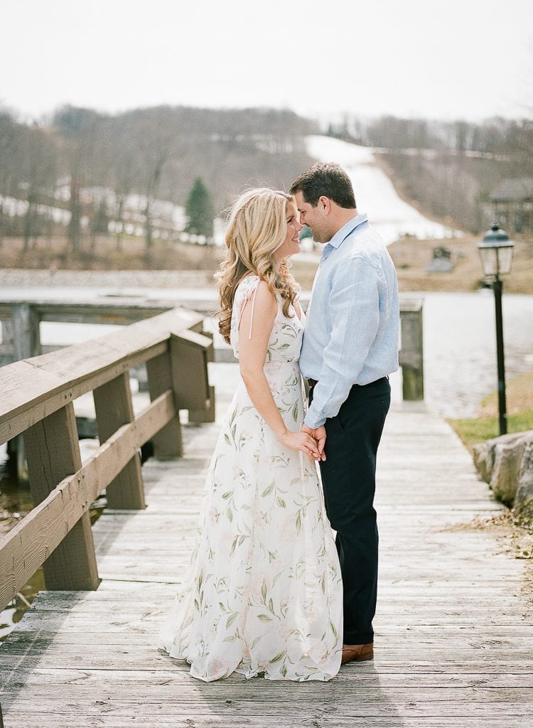 Seven Springs Engagement Photography - bride and groom holding hands together on a boardwalk