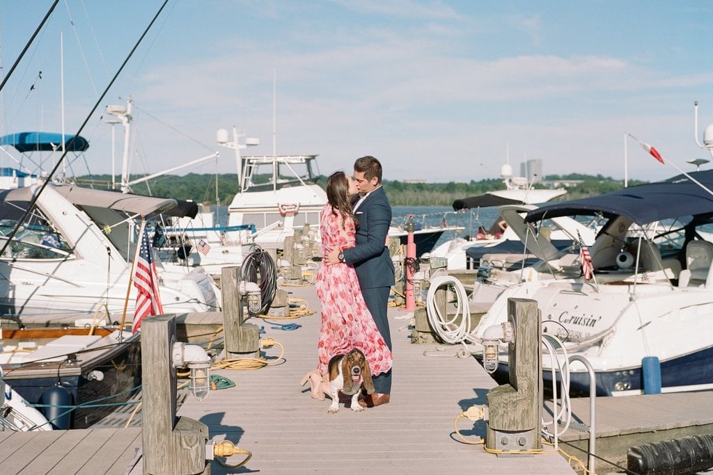 Engagement Session - Lauren Renee Photography Couple kissing while walking their hound dog on the docks on Old Town Harbor in Virginia