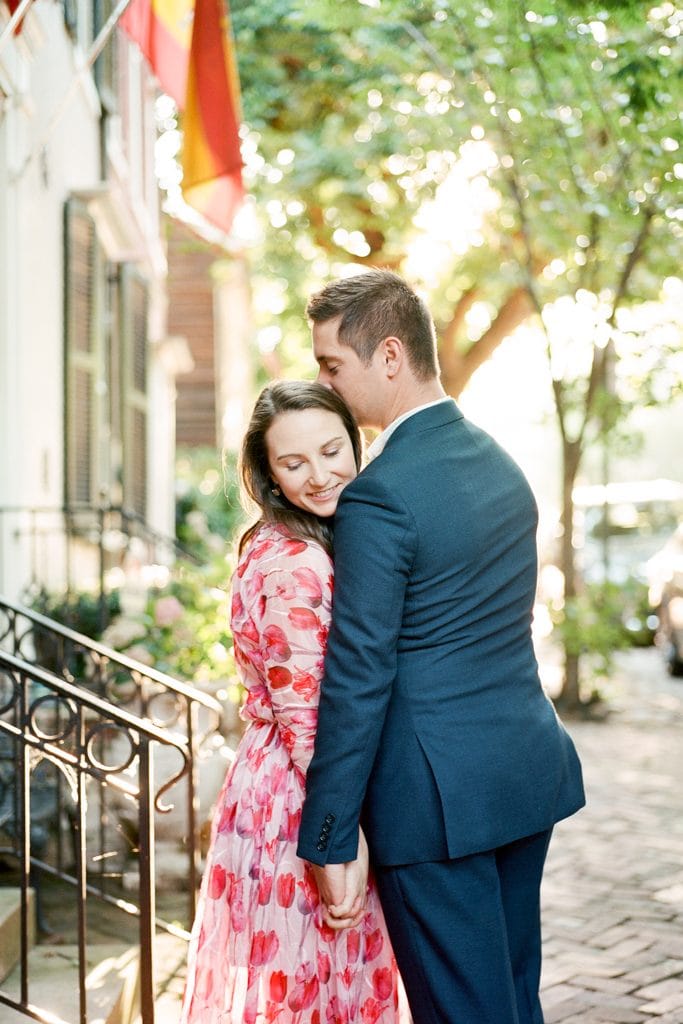 couple embracing during engagement photos in Old Town Alexandria