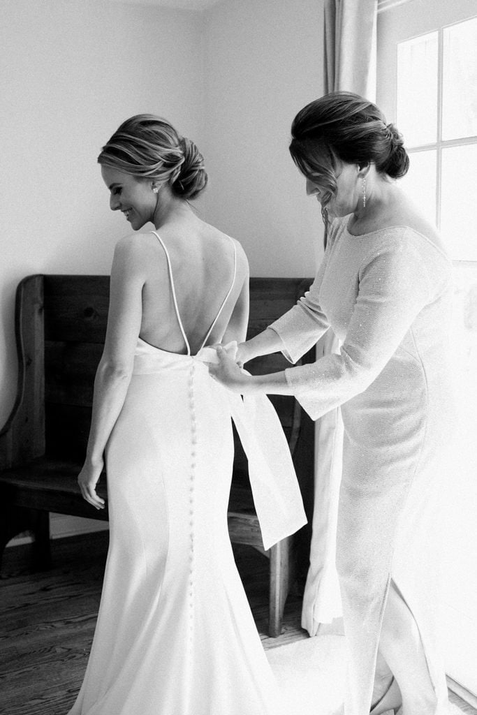 The Pennsylvanian bride getting dressed in Mikaella by Paloma Blanca bridal dress