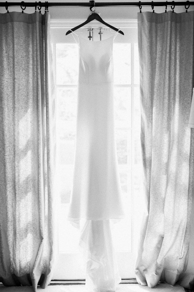 Black and white photo of brides Mikaella by Paloma Blanca wedding dress