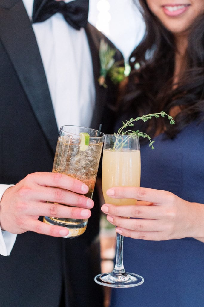 Guests holding signature cocktails during cocktail hour