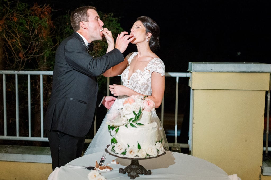 Bride and groom feeding each other cake