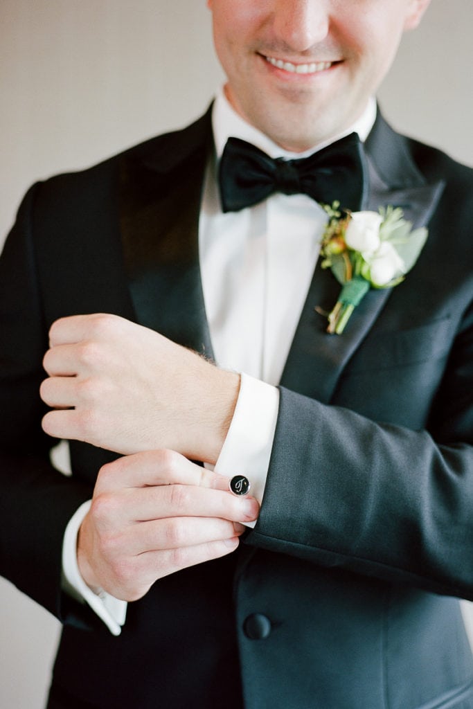 Groom fixing his cufflinks