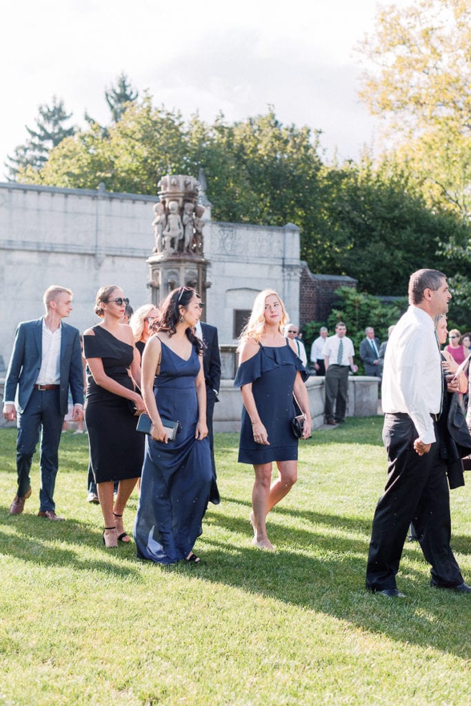 Guests as they take their seats of the wedding ceremony in the walled garden