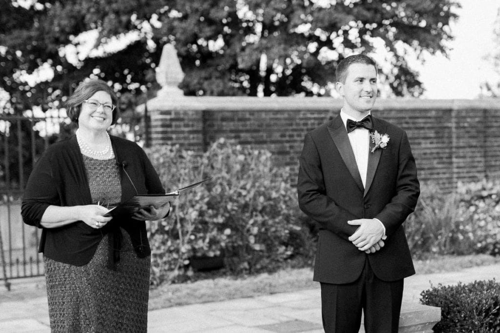 Groom watching his bride walk down the aisle