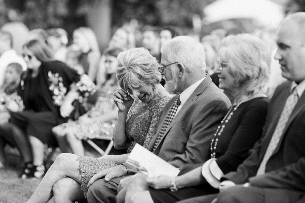 Mother of the bride wiping away tears at the ceremony