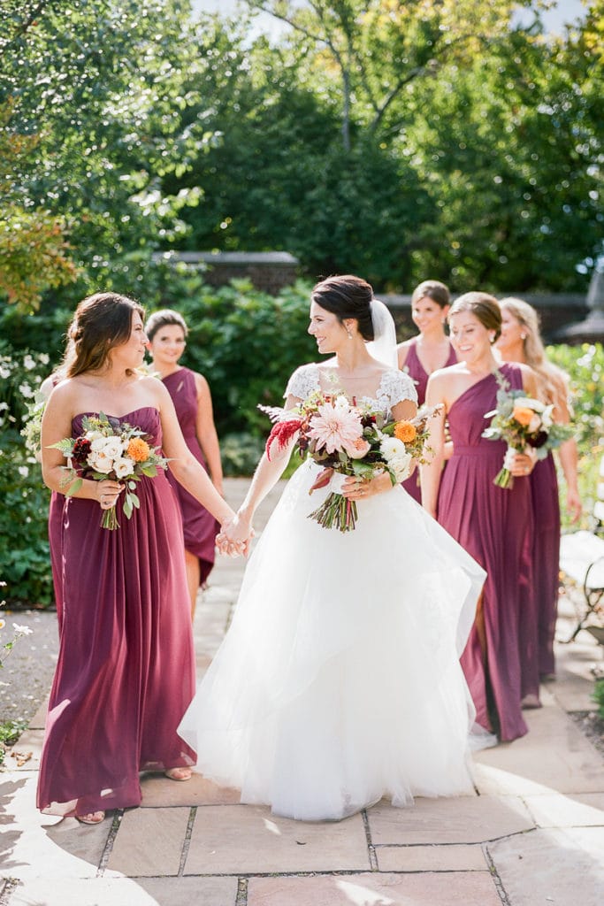 Bride walking and smiling with her bridesmaids