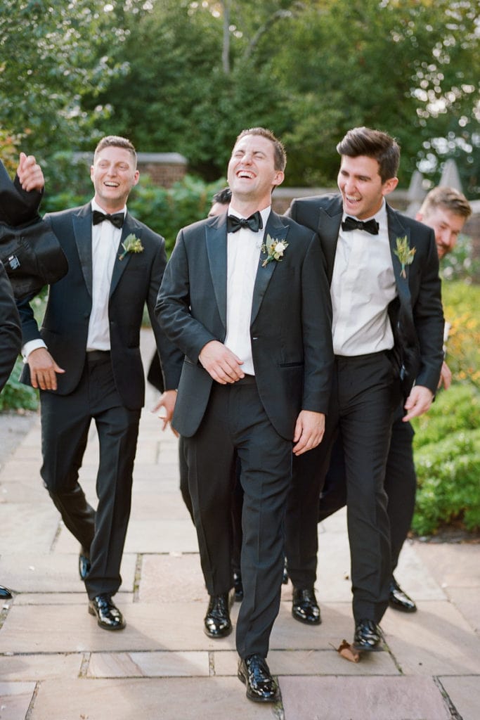 Groom laughing and joking with his groomens