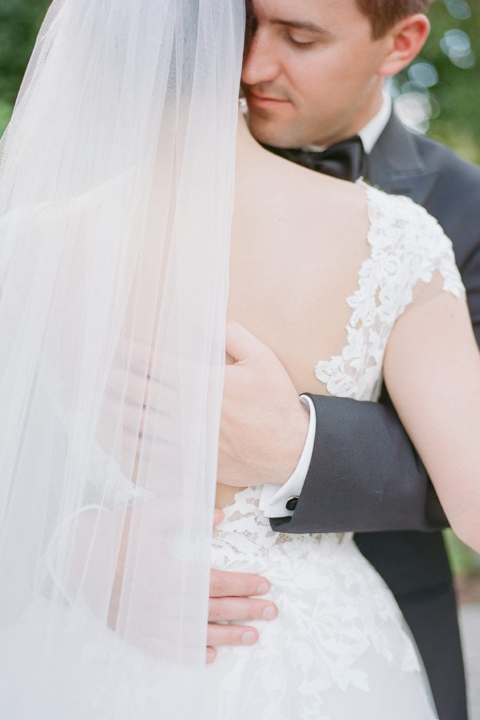 Groom nuzzling into his brides neck