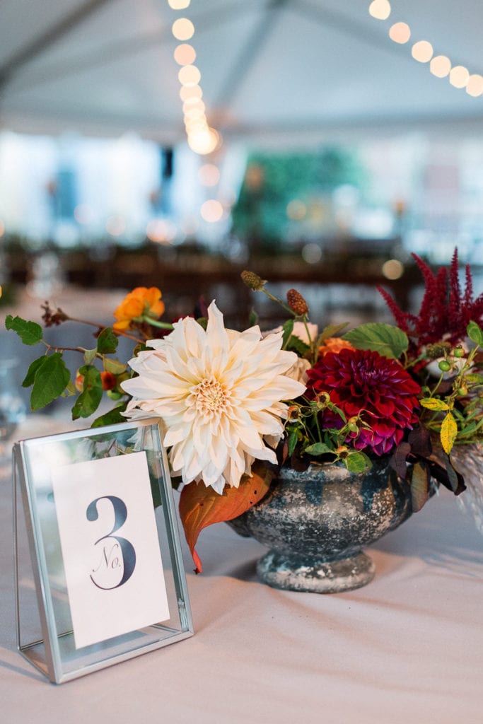 Table decor with signage and The Farmer's Daughter Flowers