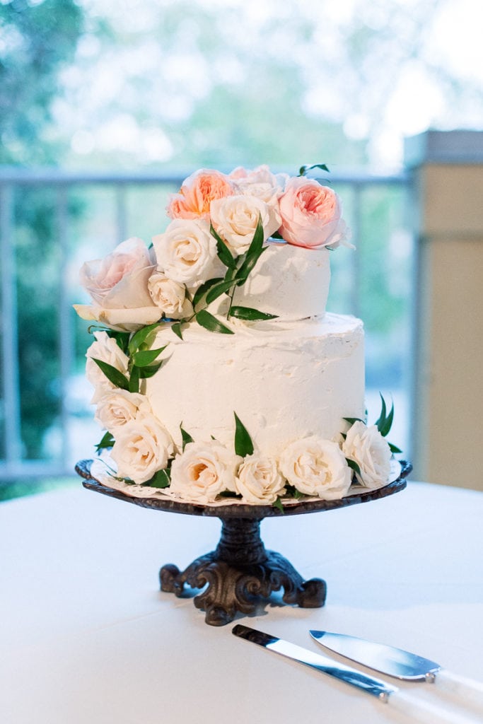 Wedding cake decorated with light pink flowerrs