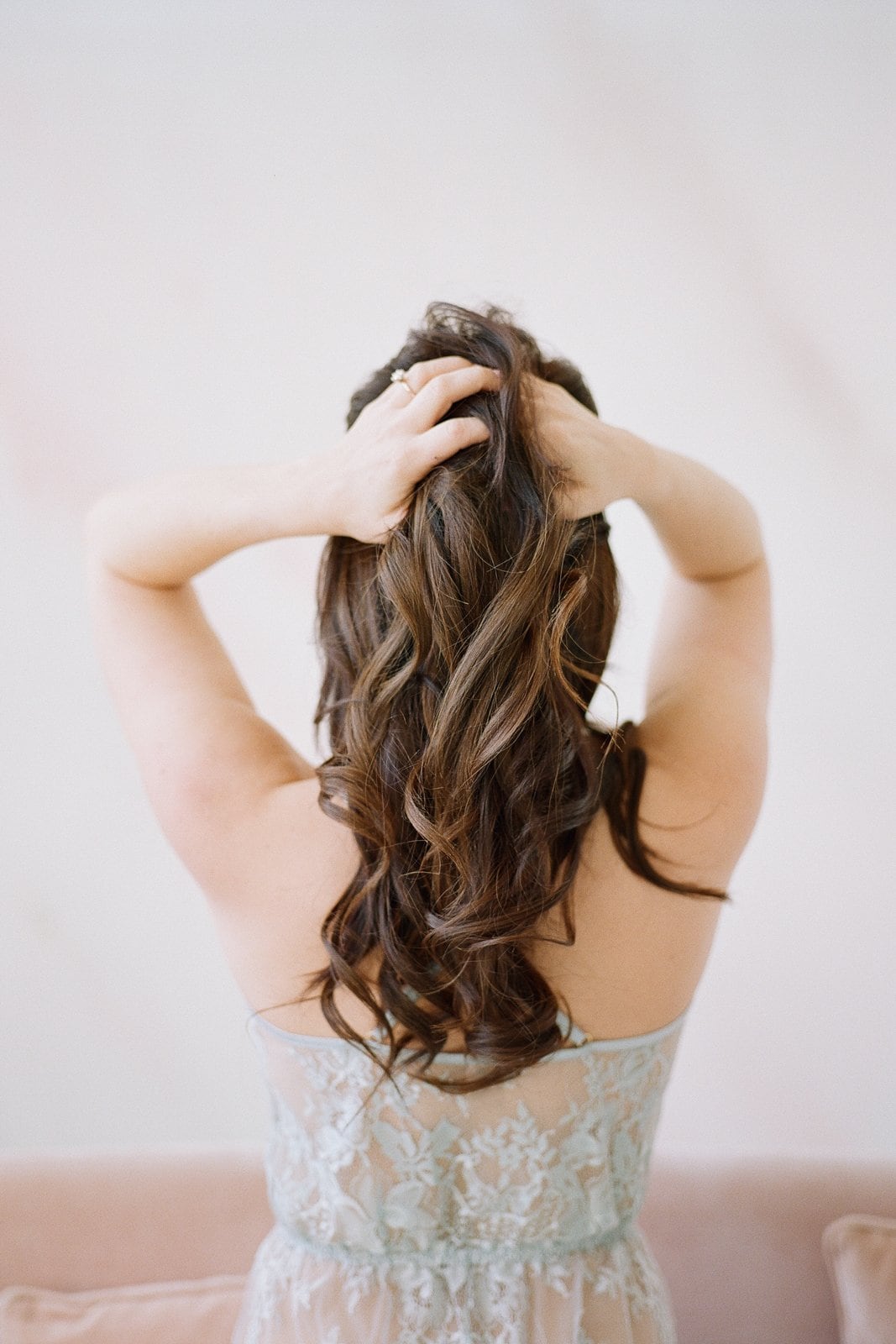 photo of the back of a woman and her hands through her hair: Pittsburgh Boudoir Photography