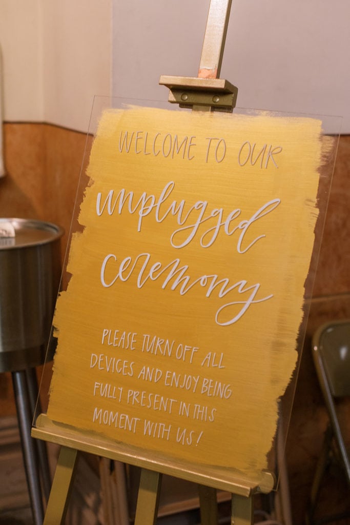Unplugged ceremony sign outside of the church