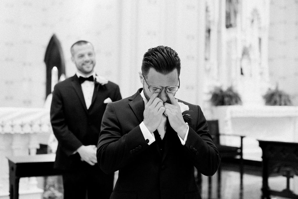 Groom seeing his bride walk down the aisle for the first time