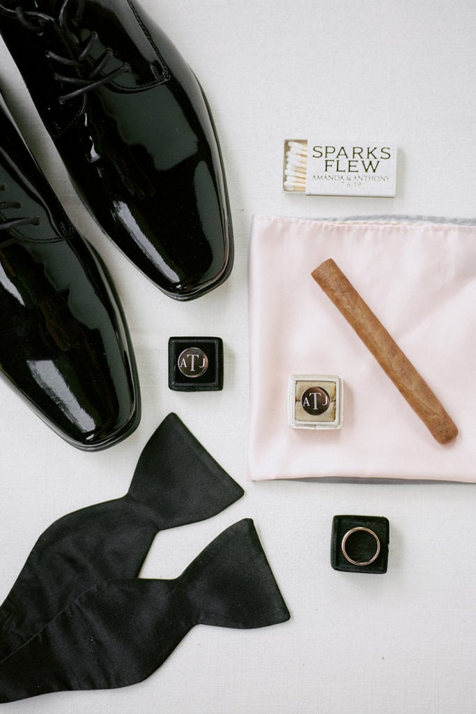 Groom's details with pink pocket square and cigars