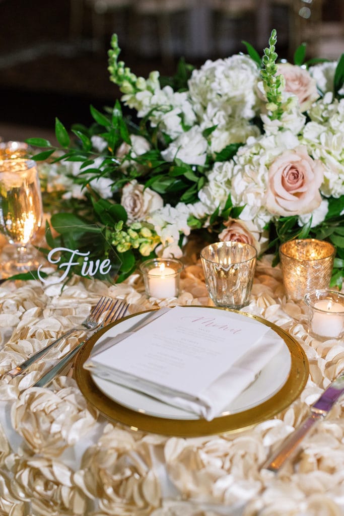 Place setting with pink and gold accents and mosaic linens