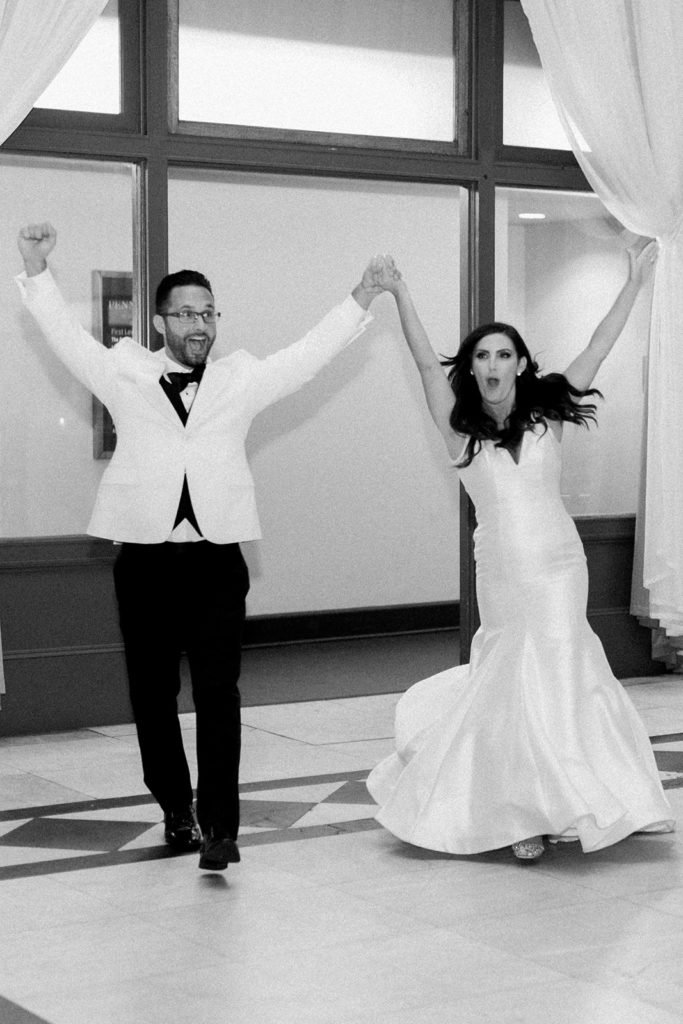 Bride and groom entering into their wedding reception at the Pennsylvanian