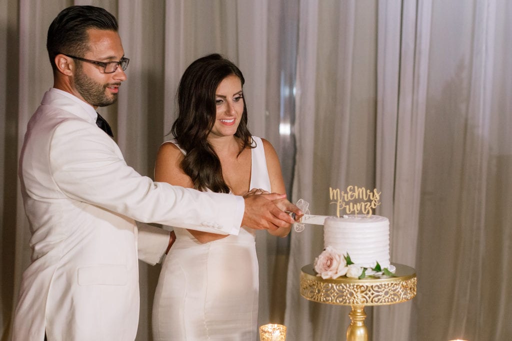 bride and groom cut their Oakmont Bakery wedding cake