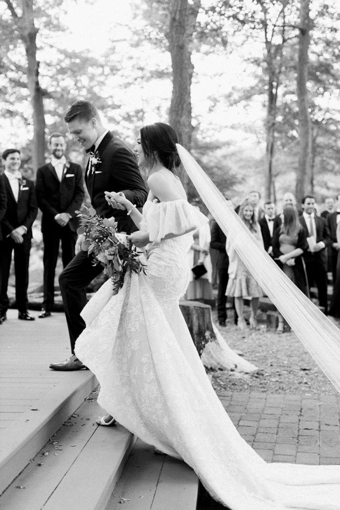 Groom escorting his bride up to the altar for their wedding ceremony