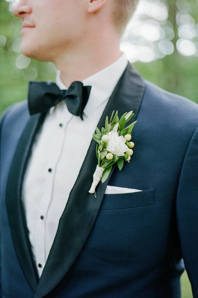 close up of grooms tux and boutonnière