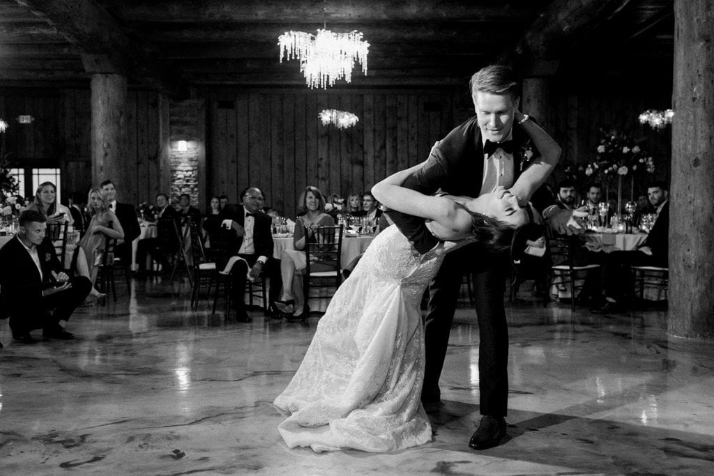 Groom dipping his bride during their first dace