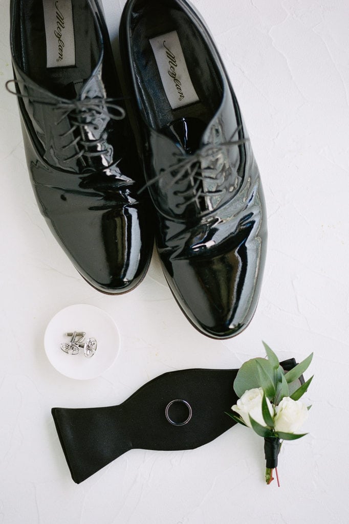 Groom's wedding shoes and white wedding boutonniere