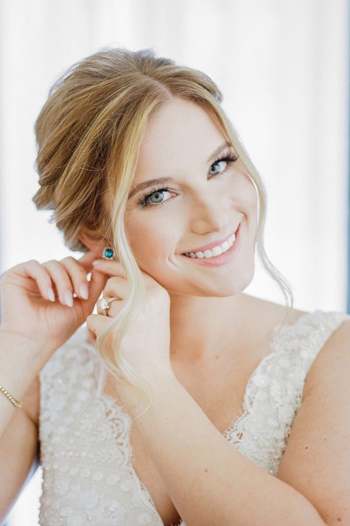 Bride putting in her earrings