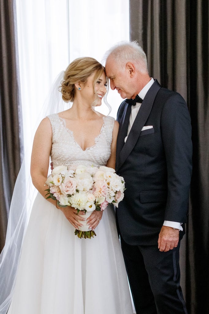 Sweet moment of bride with her father the morning of her wedding