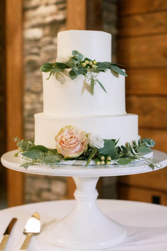 White and greenery wedding cake: Outdoor Fall Seven Springs Wedding captured by Pittsburgh Wedding Photographer Lauren Renee