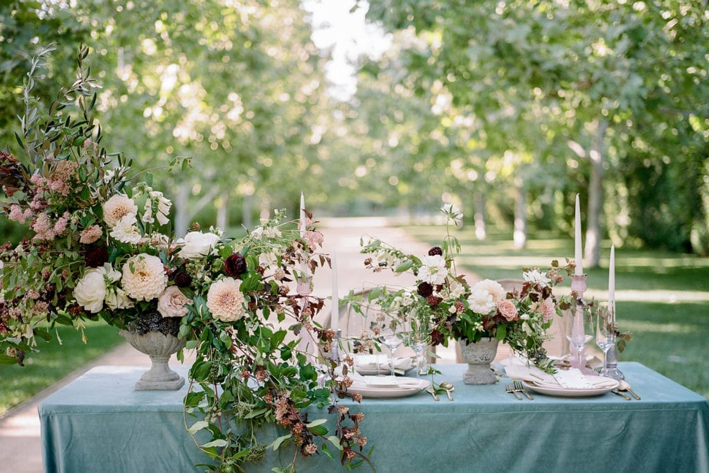 Elegant velvet table linen with blue and purple accent flowers from Emily Reynolds Design