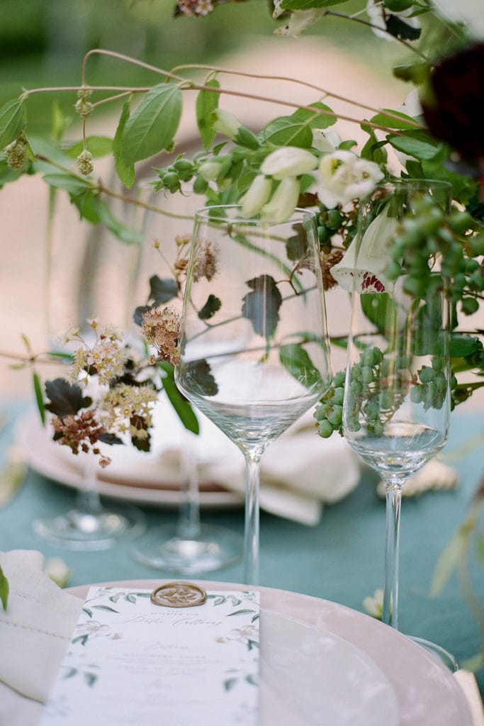 Table decor detail blue velvet linen and pink dishesCeremony Arch with flowers by Emily Reynold Design: Kestrel Park California Wedding Inspiration Styled Shoot captured by Pittsburgh Wedding Photographer Lauren Renee