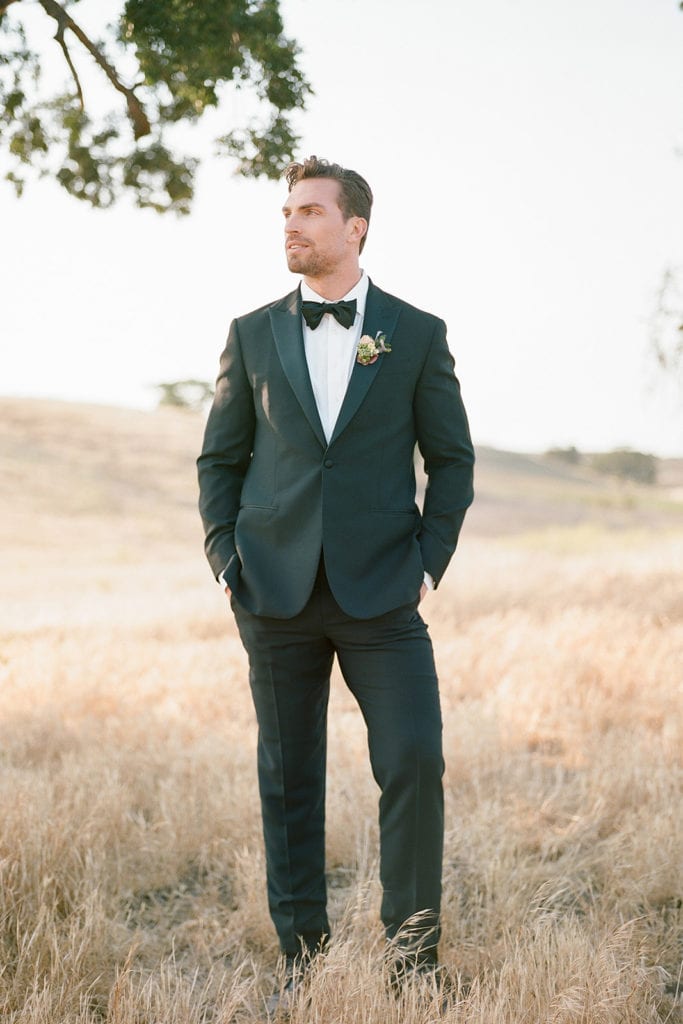 The Black TuxCeremony Arch with flowers by Emily Reynold Design: Kestrel Park California Wedding Inspiration Styled Shoot captured by Pittsburgh Wedding Photographer Lauren Renee