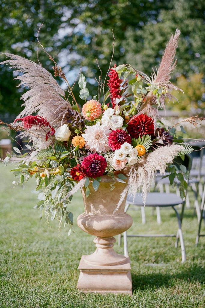 Flowers urns with red and orange color palette from the Farmer's Daughter Flowers