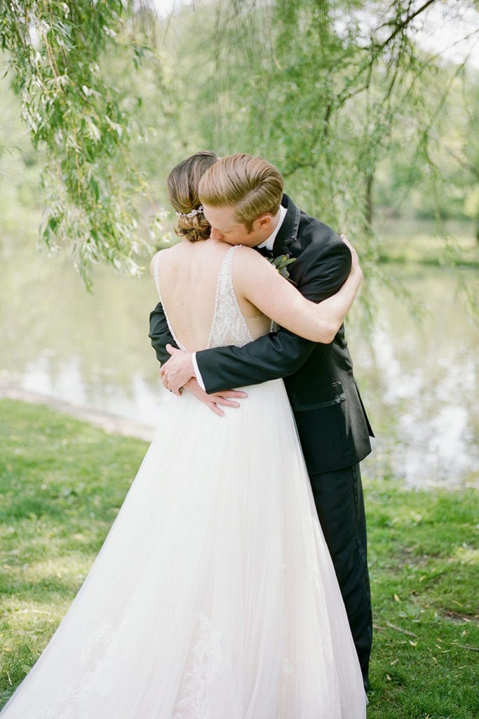 Bride and groom hugging during first look: How to Choose a Wedding Photographer by Lauren Renee