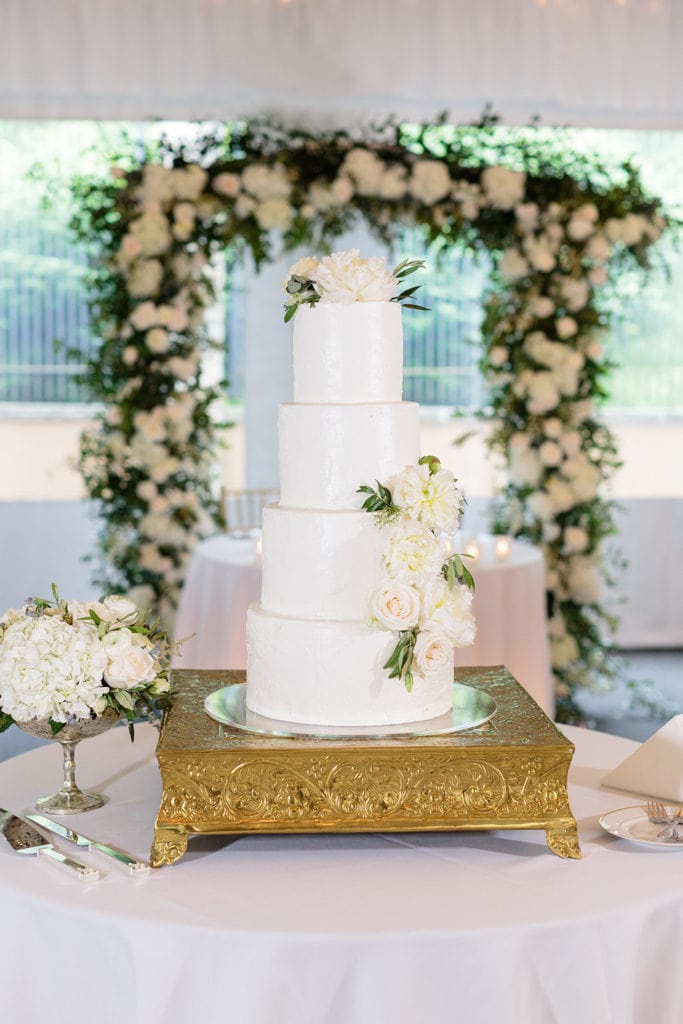 Four tier white wedding cake with flowers