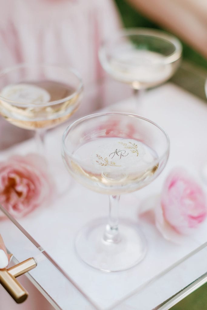 Champagne toast with custom monogram printed on sugar paper