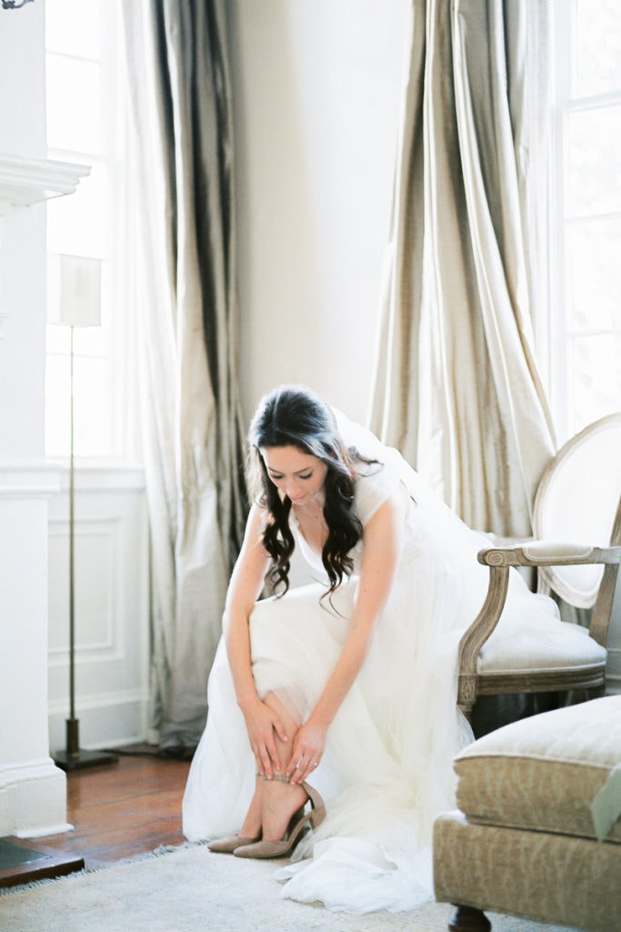 Bride putting on her Manolo blahnik shoes and watters dress at Zero George St. Hotel in Charleston: What I learned from my own wedding