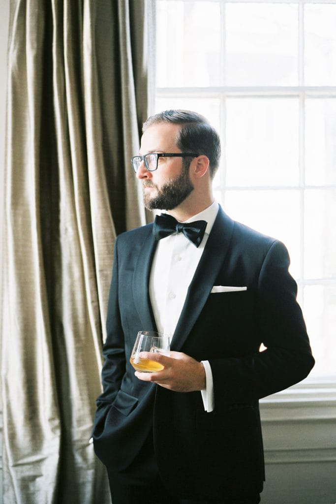 Bonobos tux and tie bar accessories groom holding a glass of whiskey: 5 things i learned from my own wedding