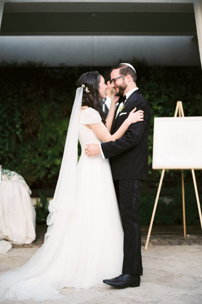 Bride and groom smiling at each other during their ceremony at Cannon Green in Charleston South Carolina: What I learned from my own wedding