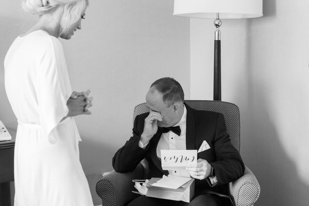 Bride giving her father a gift on her wedding day