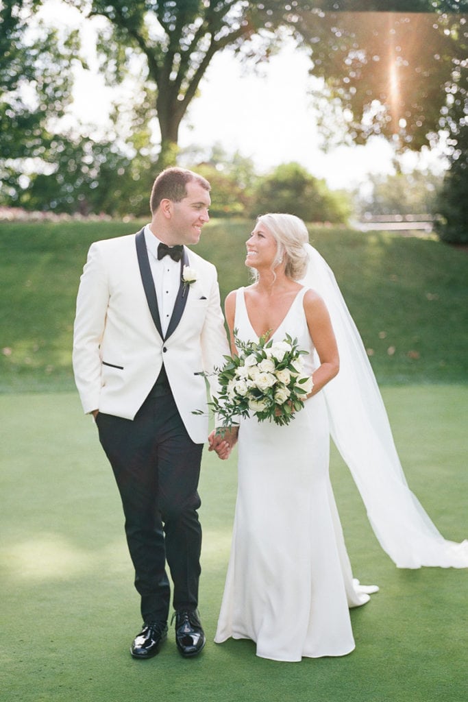 Bride and groom walking together holding hands