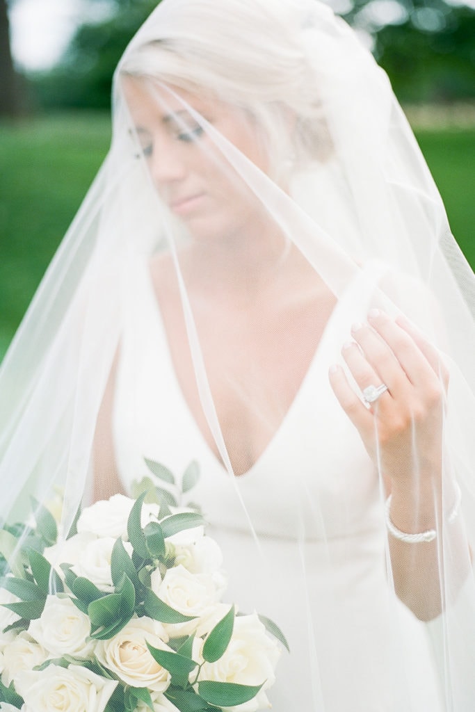 Gorgeous film portrait of bride under her veil