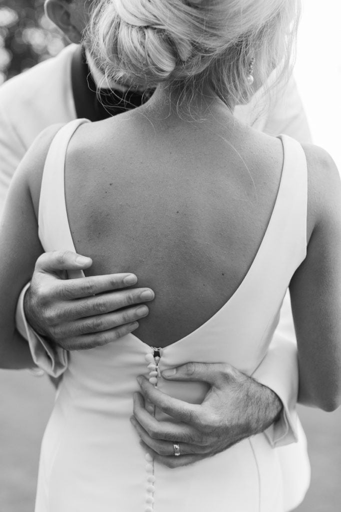 black and white photo of groom holding bride