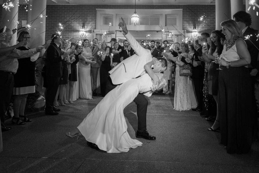 Bride and groom exiting their wedding with a sparkler send off