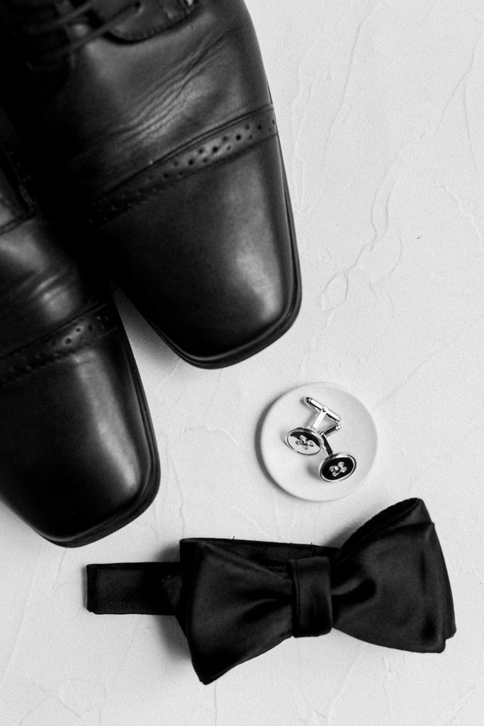 Grooms accessories with cufflinks and bow tie