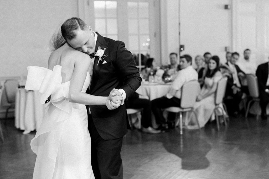 Bride and groom sharing their first dance groom putting his head on bride shoulder