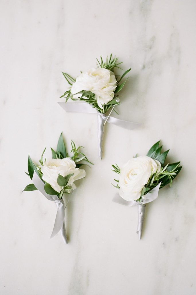 White flowers with greenery wedding boutonnieres