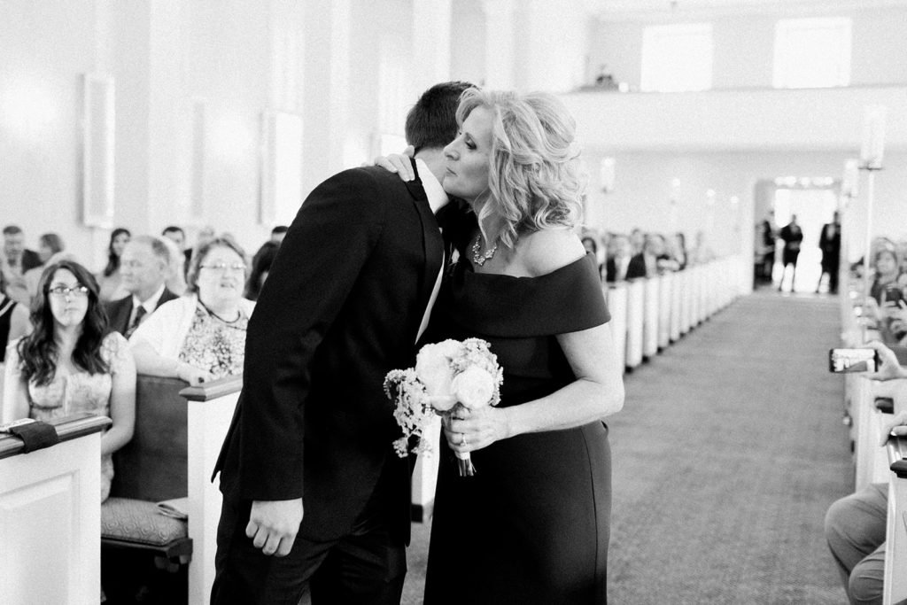 Mother of the bride escorted down the aisle